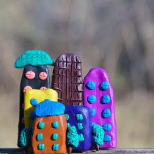 Colorful clay buildings with button windows.