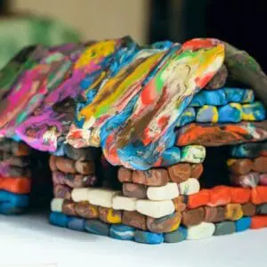Colorful clay house model with rainbow roof.