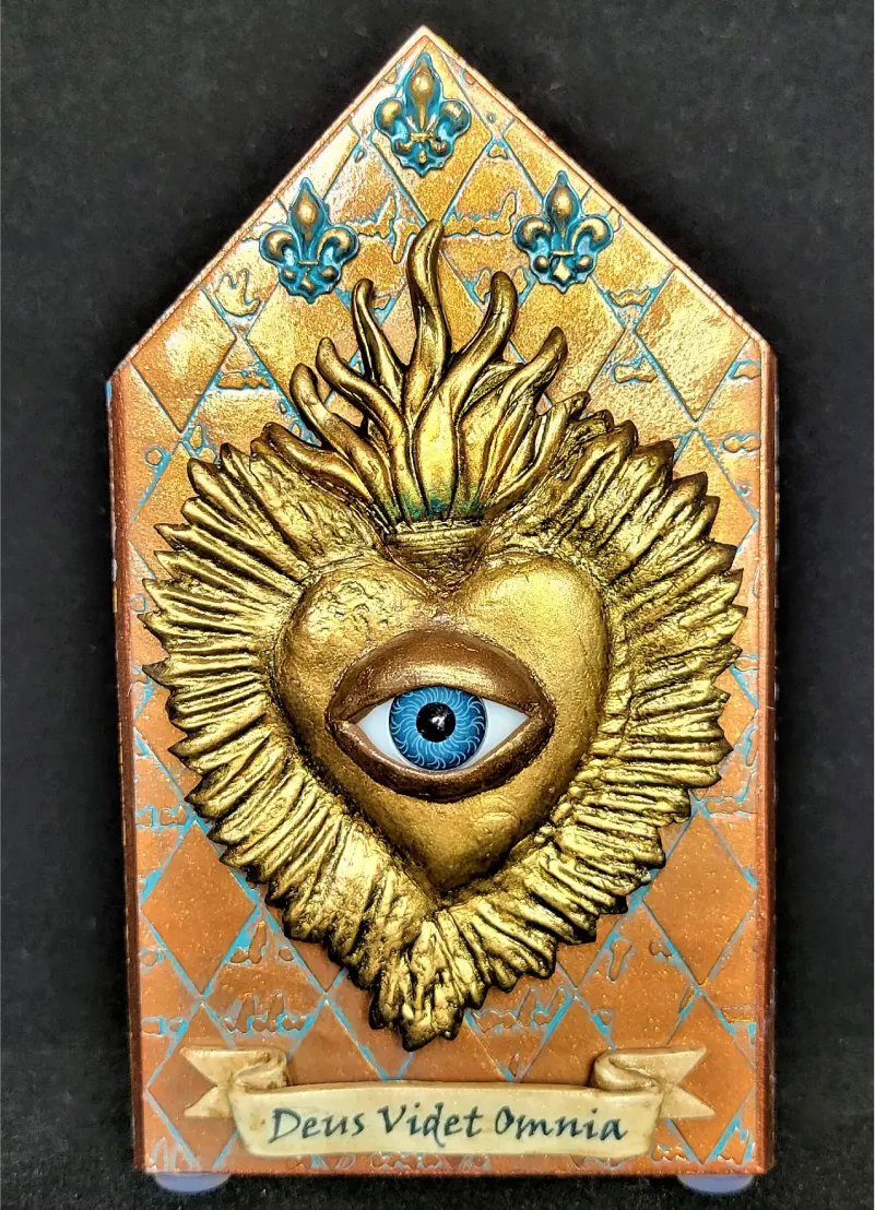 44 A gold heart with an eye in it.