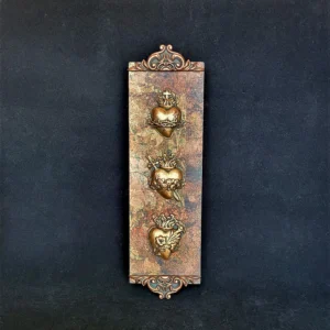 Vertical plaque with three ornate sacred hearts